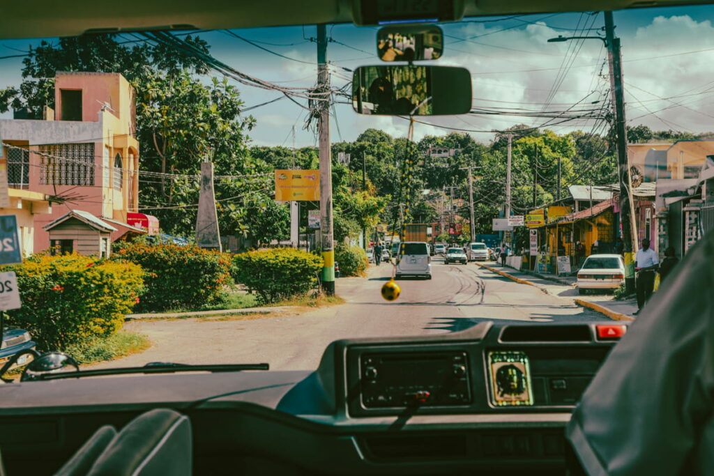 Inside a vehicle looking out at the winding roads of Jamaica, perfect for exploring new parishes