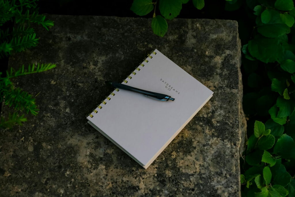 Close-up of a pen on a journal, perfect for writing out personal and professional goals.