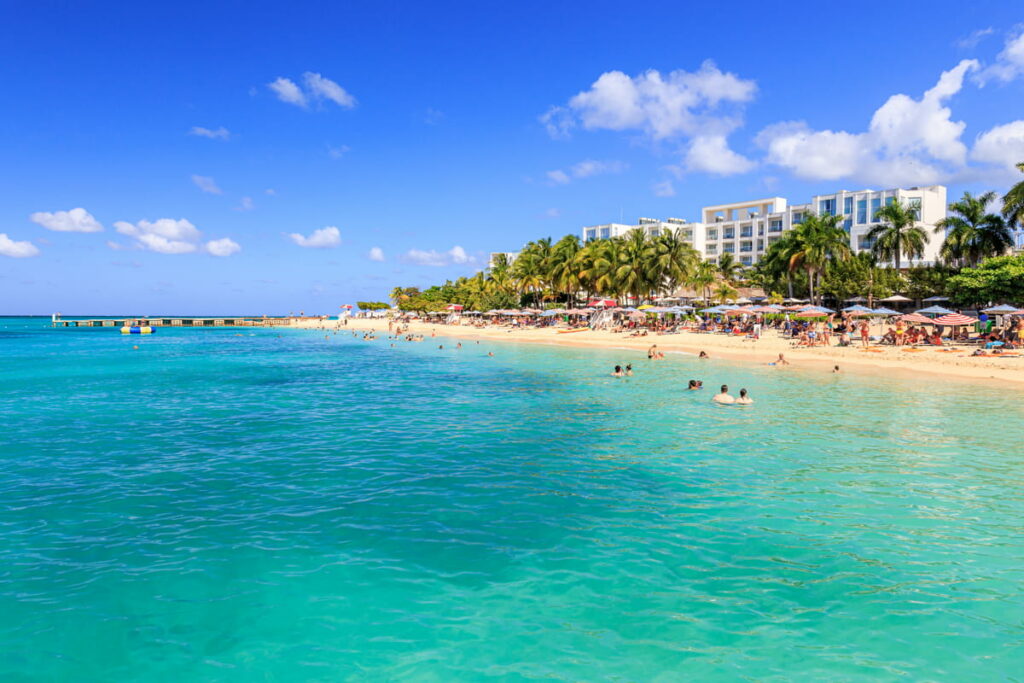 montego-bay-travel-guide A scenic view of Montego Bay, Jamaica, featuring crystal-clear waters and palm-lined beaches