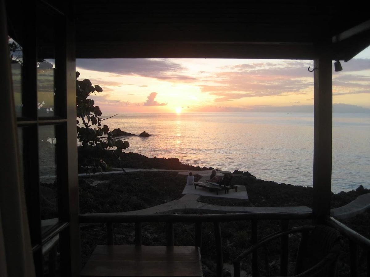 View of sunset over the Caribbean Sea from a hotel window in Negril, Jamaica