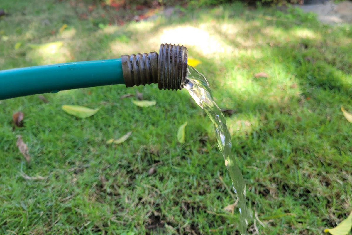 A garden hose with water flowing out in Jamaica.