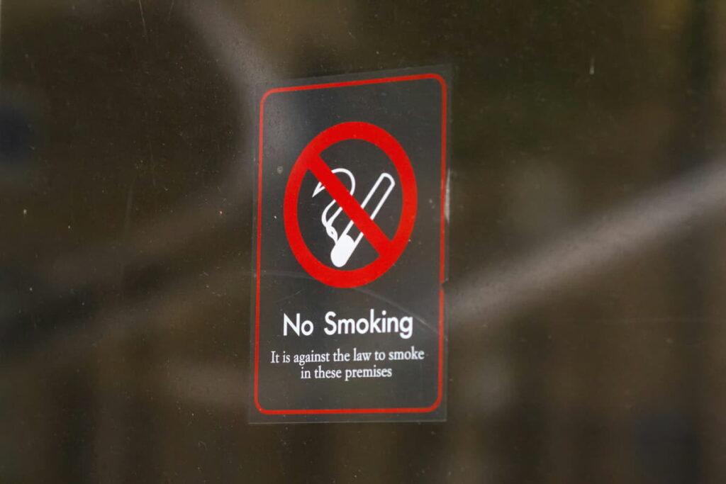 No smoking sticker on a glass door